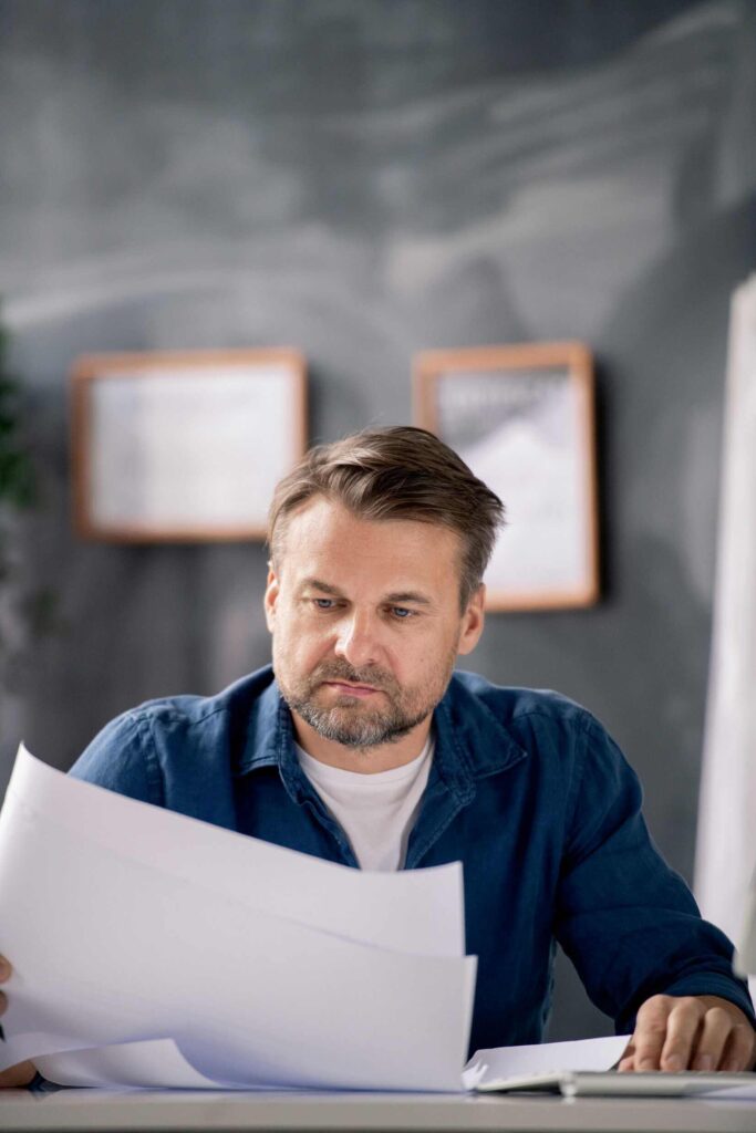 An image of bearded middle aged architect in casualwear lookin L6P53XX - Reflex Builders - DC Area Home and Business Renovations