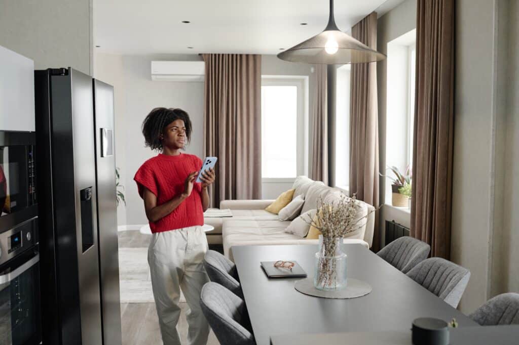 Woman Testing App for Smart Home showcasing that modern home upgrades can update any historical home interior while preserving the exterior.