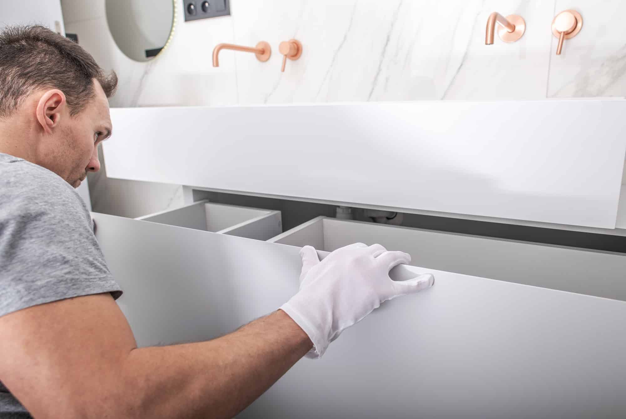 Modern Bathroom Cabinets Installation by Caucasian Worker